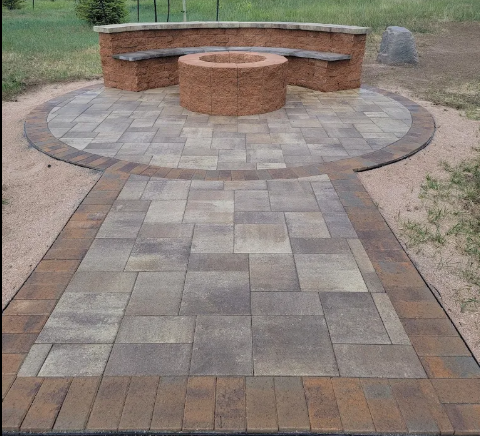 Circular paver patio with a stone masonry fire pit and curved built-in seat wall, Cheyenne, Wyoming