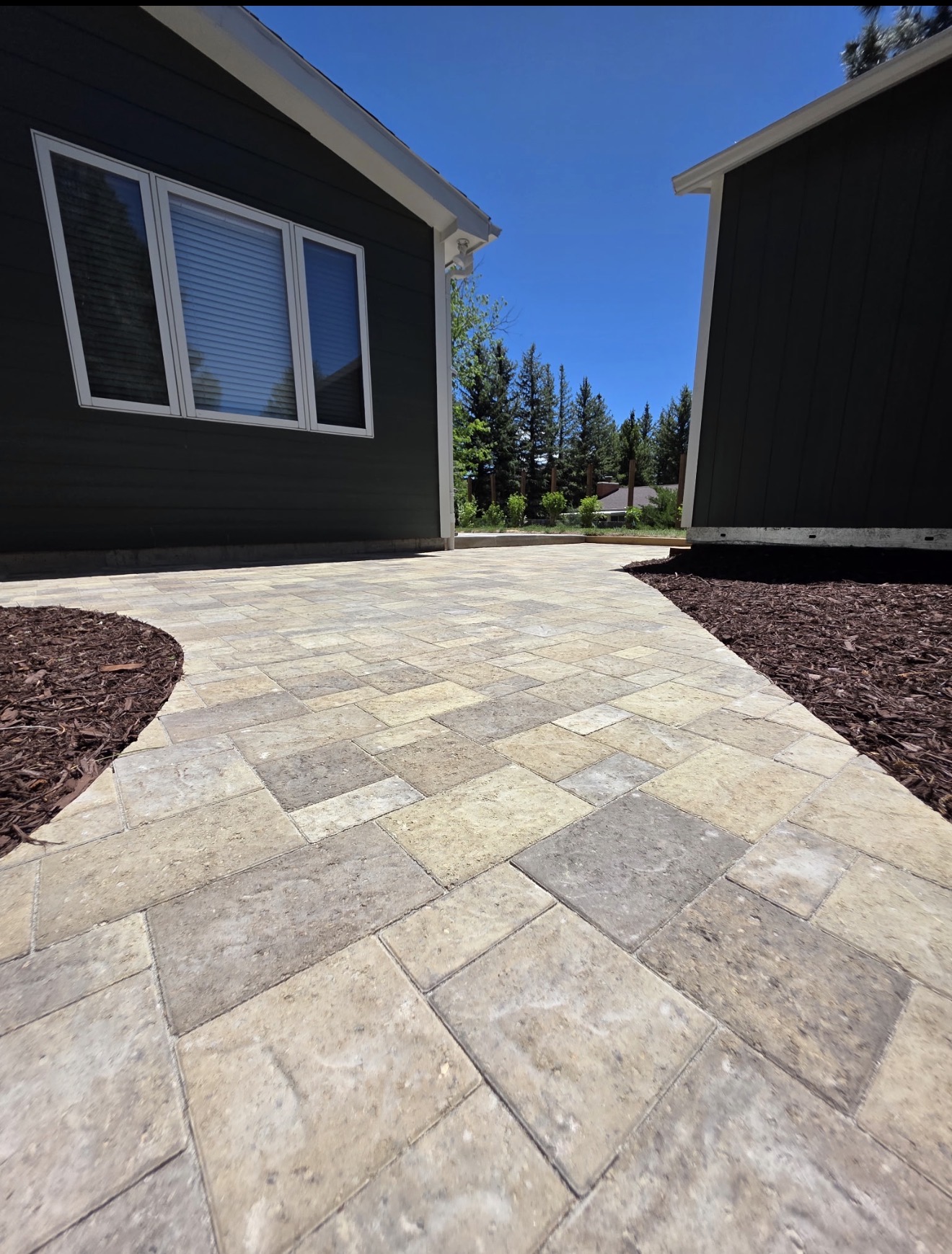 Tan and gray stone paver walkway connecting two homes, Cheyenne, Wyoming